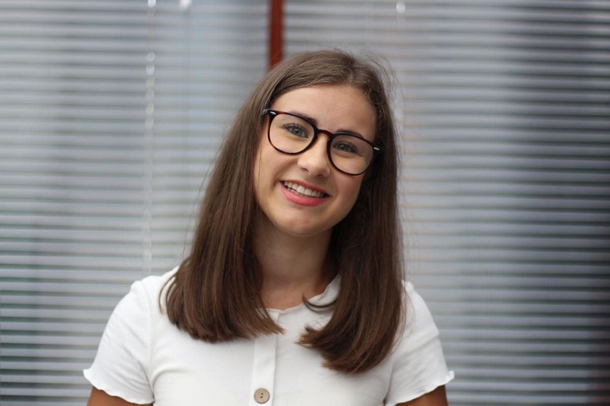 Georgia smiling with glasses and white top