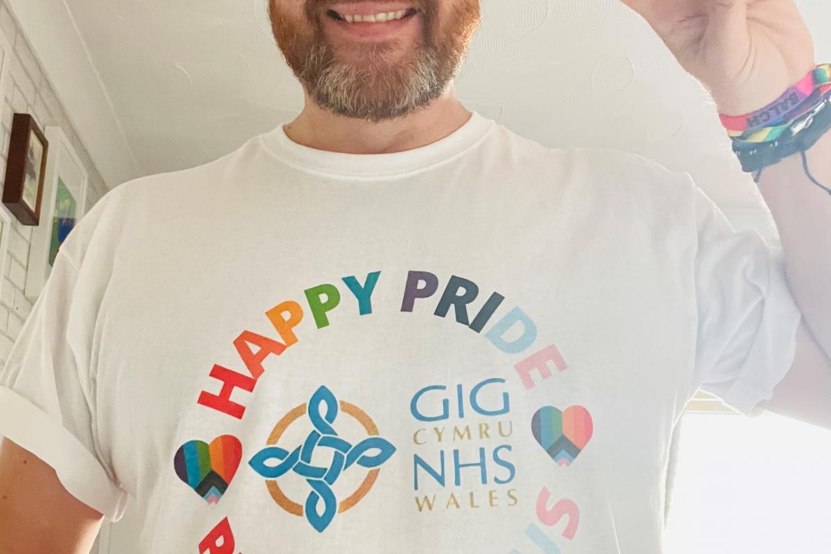 Robert smiling with a white T-shirt on