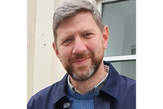 A man looking at the camera smiling