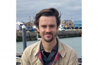 A man smiles at the camera