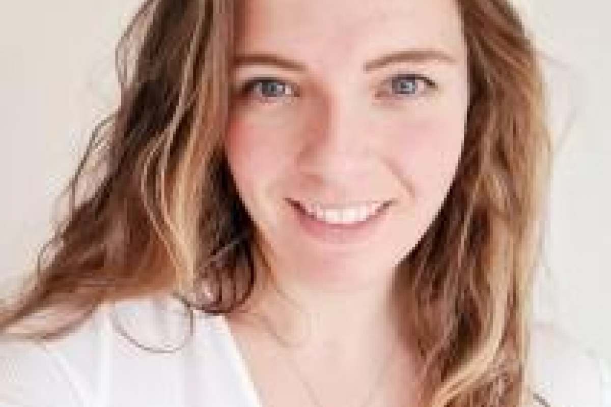 Katie smiling with a white blouse