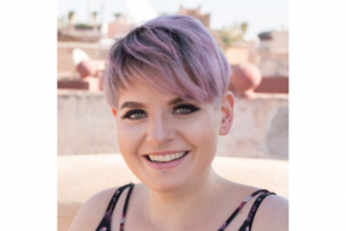 A woman smiles at the camera
