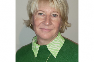 Nicola Spalding - wearing a green top and gold necklace - RCOT Fellow 2024
