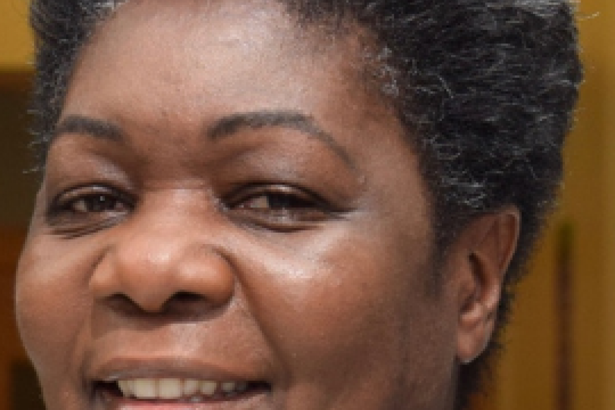 Odeth smiling with a grey and black top